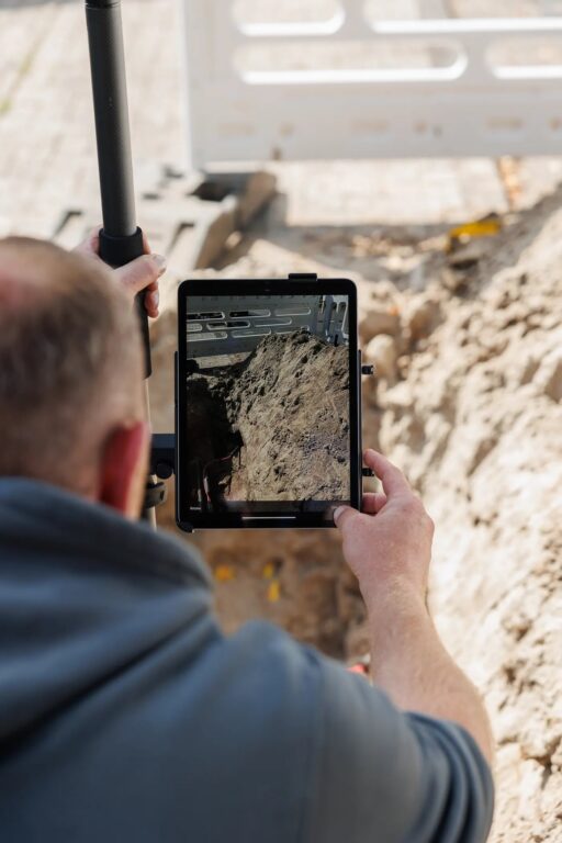 Site worker capturing an open trench in 3D with an iPad Pro and UNI-Collect