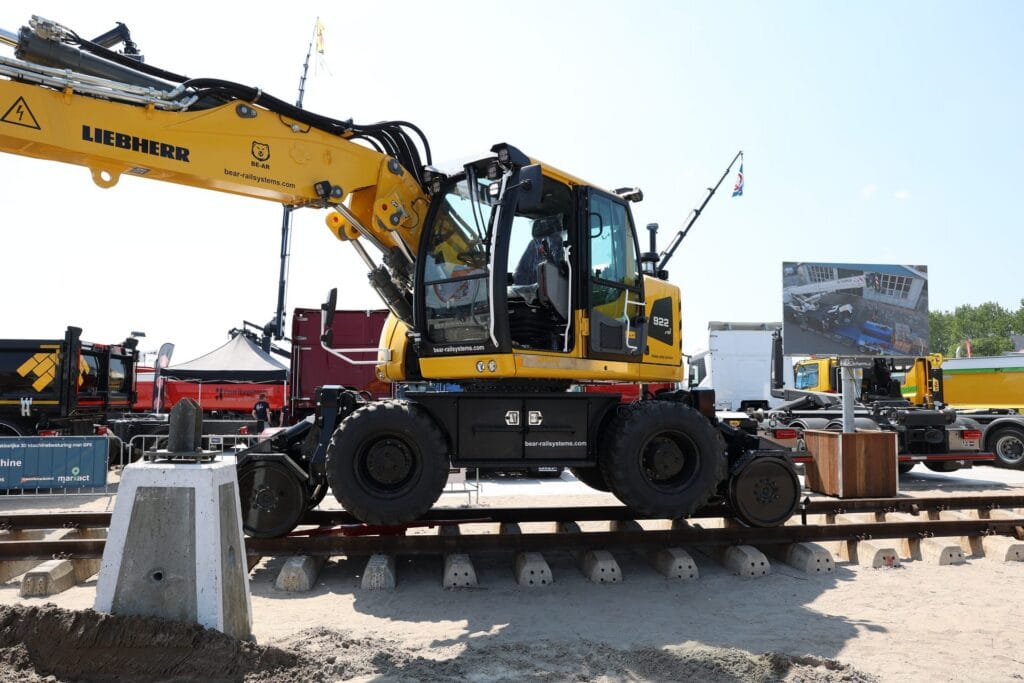 Road-rail excavator with GNSS receivers on a track, wide view